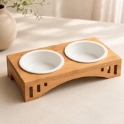 Close-up of the Arco Dining Stand bamboo feeder with two bowls